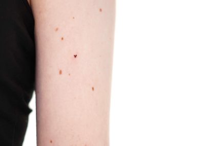Freckle heart tattoo