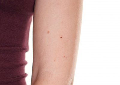 Freckle heart tattoo