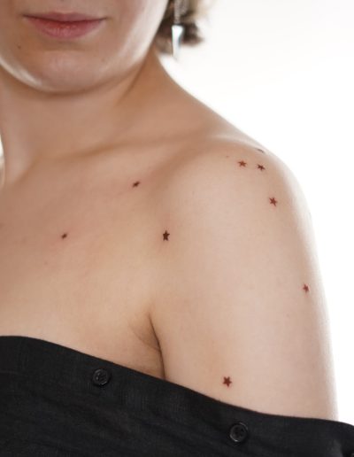 Freckle star tattoo